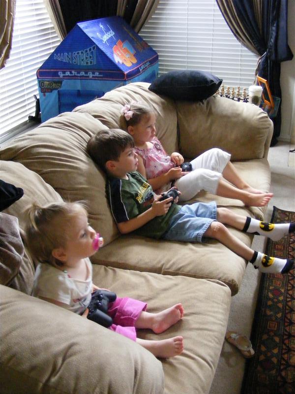 Jess_PS2WElla&Alex.JPG - I'm trying to figure out this PlayStation 2 Lego Star Wars game?  Kind of tricky, I think I like the Formula 1 better!?...  What?  My controller's upside down!?...Bugger!...